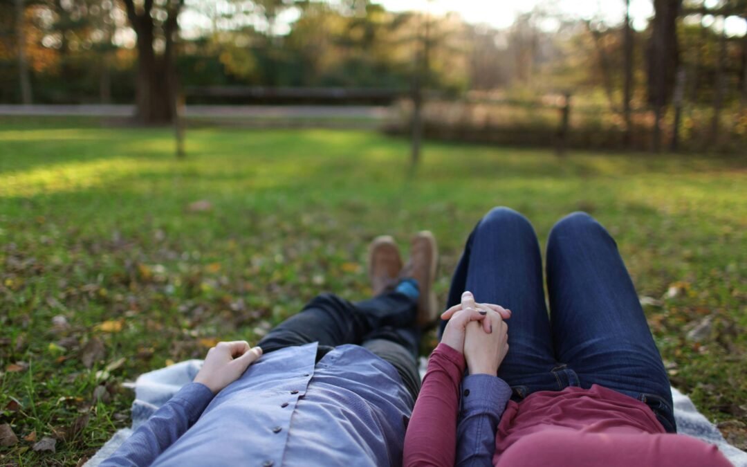 couple holding hands in a park